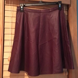 Maroon leather skirt.